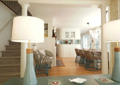 view of the dining room straight through to the kitchen with two blue lamps and table in the forefront